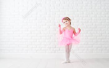 Little child girl dreams of becoming ballerina