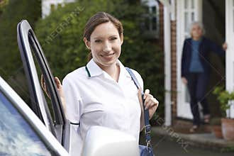 Female Care Worker Visiting Senior Woman At Home