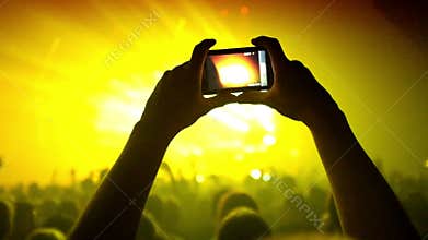 Fans waving their hands and hold the phone with digital displays