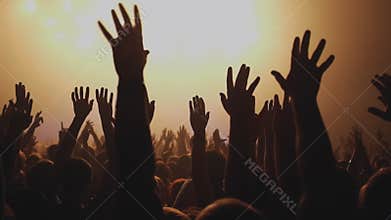 Lot of people clapping at rave party