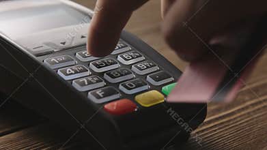 Hand swiping credit card on POS terminal