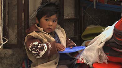 Child eating in La Paz street market, Bolivia