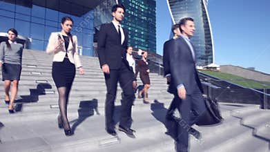 Business people go down stairs