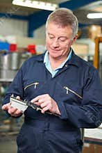 Engineer Measuring Component With Micrometer