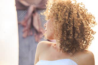 closeup side view blonde curly bride portrait on longtail boat