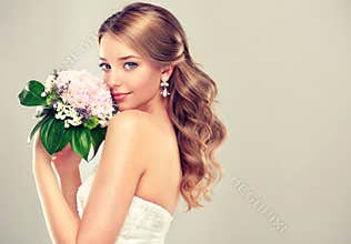 Girl bride in wedding dress with elegant hairstyle.