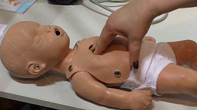 Cardiac massage on baby mannequin