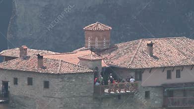 Tourists on a viewing platform of one of the monasteries in Meteora, Greece