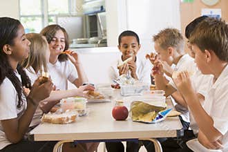 Schoolchildren enjoying their lunch in school