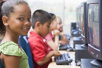 Kindergarten children learning to use computers.