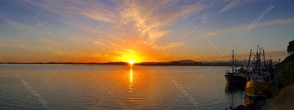 Early morning - sunrise over fishing harbor