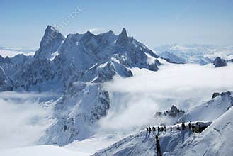 Mountain range between white clouds