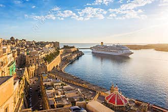 The ancient walls of Valletta and Malta harbor with cruise ship in the morning - Malta