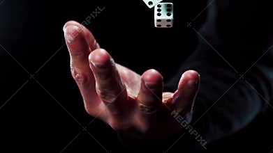 Hand catching a dice