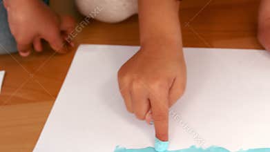 Kids finger painting on sheets of paper