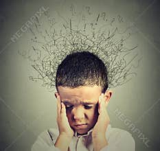 Sad boy with worried stressed face expression looking down