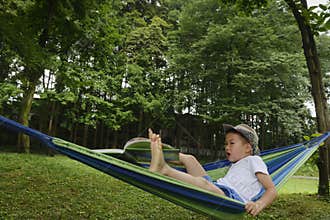 awkward kid on hammock with book away