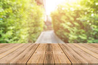 Wooden board empty table blur trees in forest background - can be used mock up for display or montage your products.