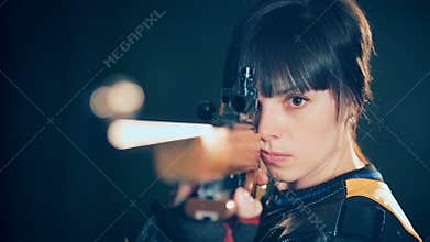 Woman training sport shooting with air rifle gun