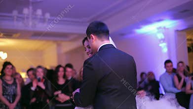 Beautiful bride and handsome groom dancing first dance at the wedding party