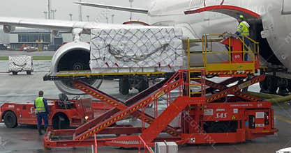 Loading cargo into plane baggage hold