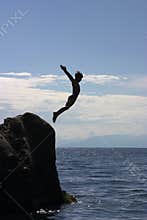 Boy jumping to the sea