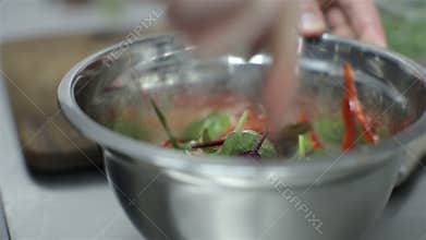 Chef stirring vegetable salad with seafood. chef cooking a vegetable salad with seafood.