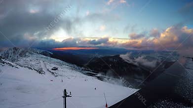 Fast running clouds over Low Tatras with magic sunset. Chopok mountain 2024 meters