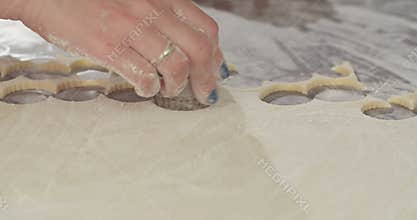 Baker cutting cookies