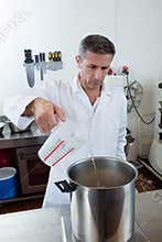 Pouring and weighting water on industrial scale for craftsmanship specialty