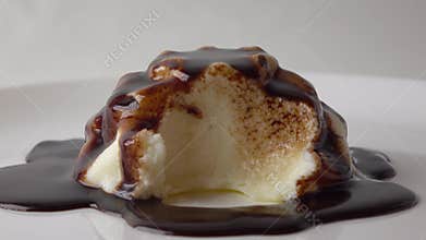 Taking a piece of pudding and chocolate sauce with a tea spoon 4K video