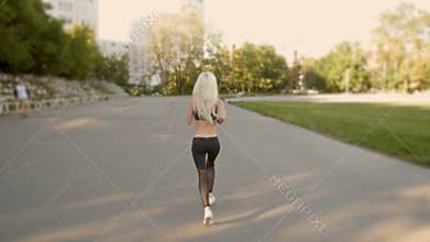 Athletic Blonde Woman Running. Female Runner Jogging. Outdoor Workout.