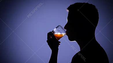 Man depressed and drinking alcohol. Blue. Close up