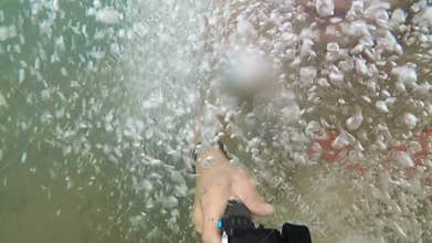 Extremely High POV Cliff Jump into Water above a Waterfall Trees and Rocks Below on a Beautiful Sunny Day in Summer in the Forest