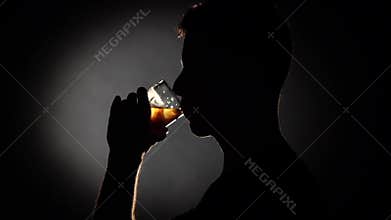 Alcoholic man drinking whiskey. Grey. Close up. Slow motion