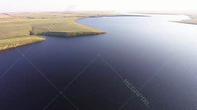 Flying over the big river. Aerial view from copter.