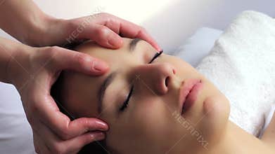 Relaxing female facial massage.