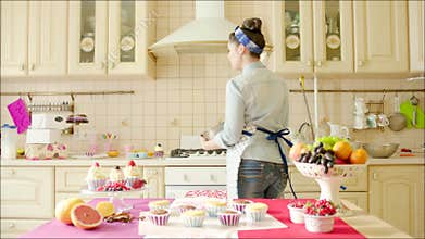 Girl dancing with utility whisk in the kitchen
