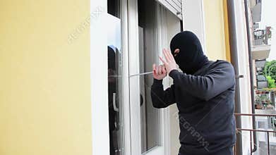 Burglar crashing a window