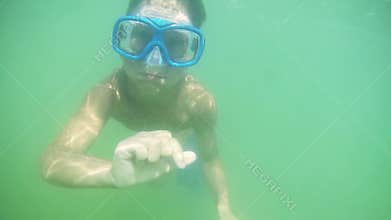 Two kids diving in the sea together