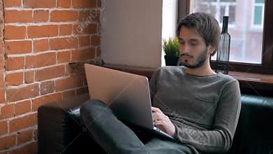 Young Entrepreneur Freelancer Working using a Laptop and in Coworking