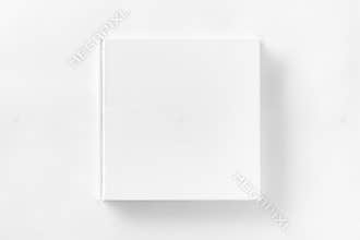 Mockup of closed blank square book at white textured paper