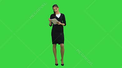 Pretty business woman giving presentation using digital tablet on a Green Screen, Chroma Key