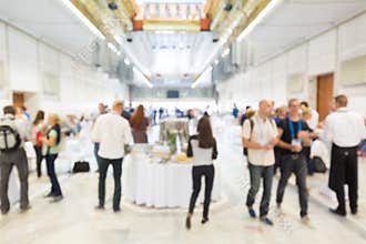 Abstract blurred people socializing during lunch break at business conference.