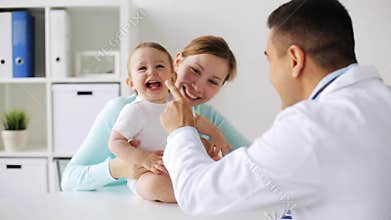 Happy woman with baby and doctor at clinic