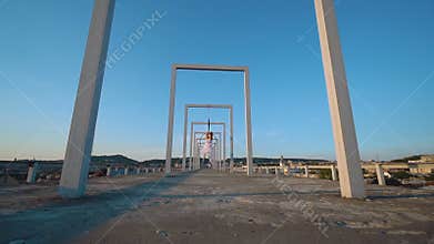 Air gymnastics woman hanging on aerial hoop on the roof with a nice view