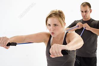 Woman exercising with personal trainer