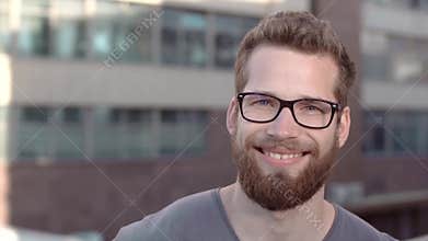 Portrait of young handsome bearded men in glasses.