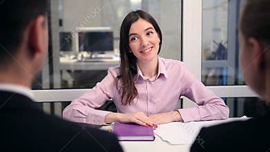 Smiling financial advisor shaking hand with couple