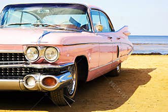 Classic pink Cadillac at beach